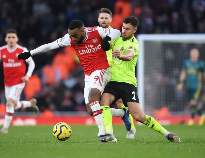 Framed Print : Intense Face-Off: Lacazette vs. Baldock in Arsenal's Battle Against Sheffield United Framed Print : Intense Face-Off: Lacazette vs. Baldock in Arsenal's Battle Against Sheffield United