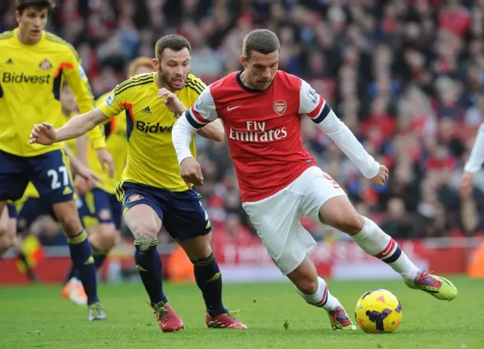 Framed Print : Intense Face-Off: Lukas Podolski vs. Phil Bardsley in Arsenal's Battle Against Sunderland
