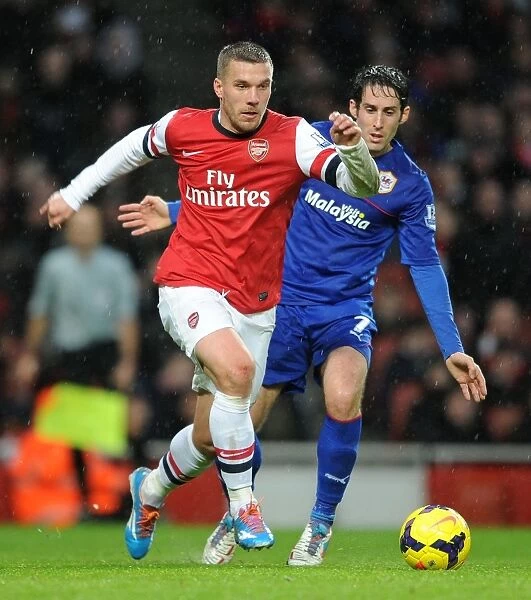 Intense Face-Off: Podolski vs. Whittingham - Arsenal's Lukas Podolski and Cardiff's Peter Whittingham Lock Horns in Premier League Clash