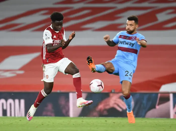 Framed Print : Intense Premier League Clash: Saka vs Fredericks - Foul at Arsenal's Emirates Stadium
