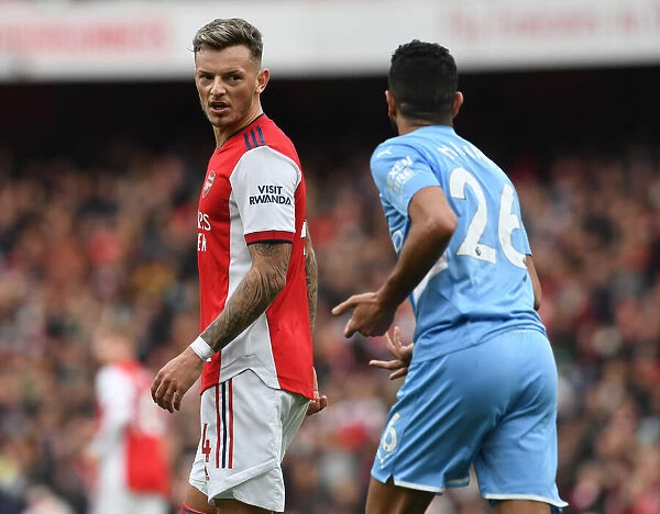 Intense Rivalry: Ben White and Riyad Mahrez Lock Eyes in the Arsenal vs. Manchester City Clash