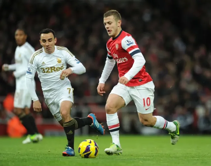 Framed Print : Intense Rivalry: Jack Wilshere vs Leon Britton Clash in the 2012-13 Premier League Framed Print : Intense Rivalry: Jack Wilshere vs Leon Britton Clash in the 2012-13 Premier League