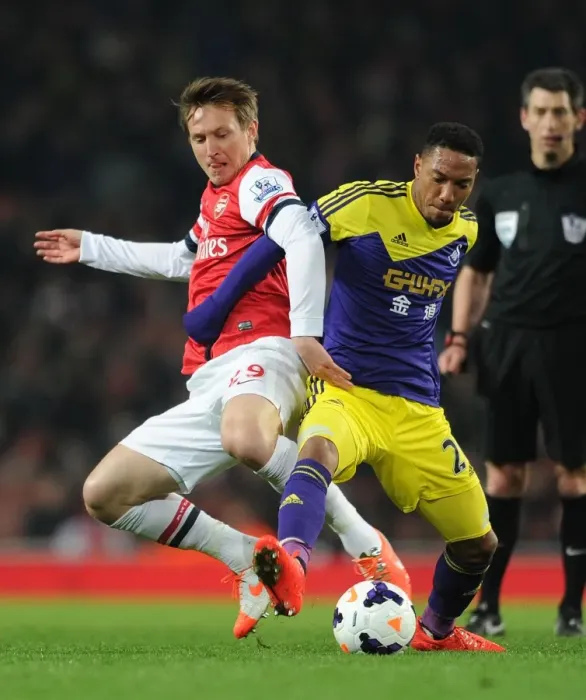 Framed Print : Intense Rivalry: Kallstrom vs. De Guzman - Arsenal vs. Swansea Football Battle Framed Print : Intense Rivalry: Kallstrom vs. De Guzman - Arsenal vs. Swansea Football Battle