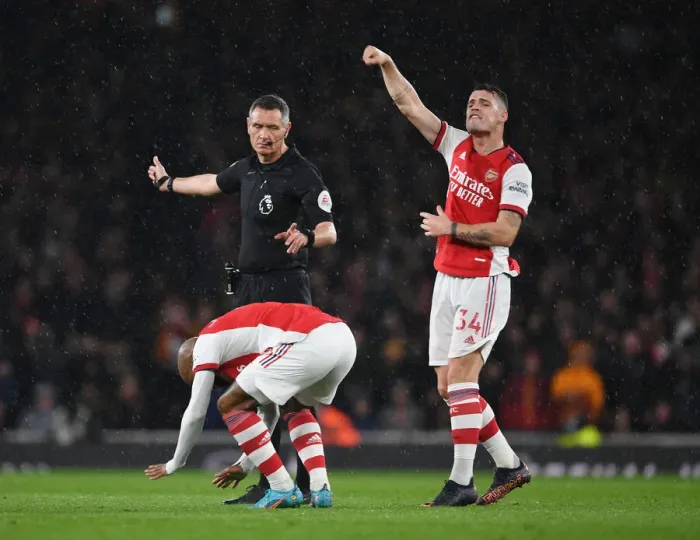 Framed Print : Intense Rivalry: Lacazette and Xhaka's Reaction to Referees Controversial Decision in Arsenal vs. Liverpool