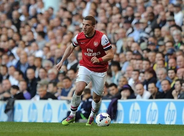 The Intense Rivalry: Lukas Podolski Faces Off in the Battle of North London - Tottenham Hotspur vs. Arsenal, Premier League 2013-14