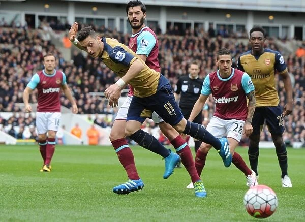 Intense Rivalry: Mesut Ozil vs James Tomkins Clash in Arsenal's Victory over West Ham United, 2016