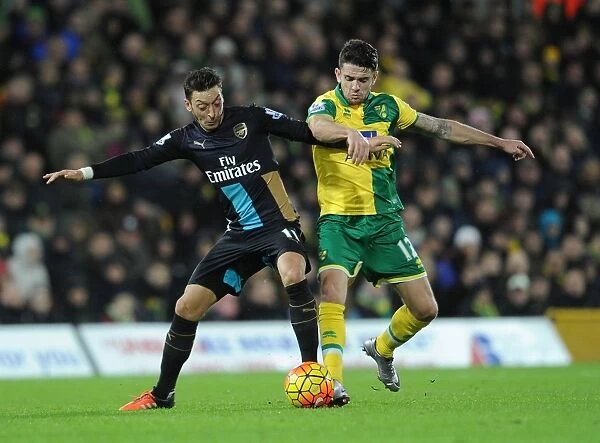 Intense Rivalry: Mesut Ozil vs. Robbie Brady Clash in Norwich City vs. Arsenal Premier League Match