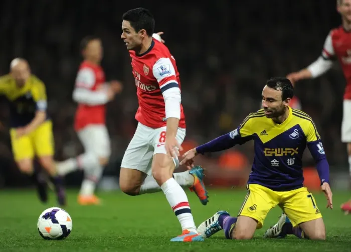 Framed Print : Intense Rivalry: Mikel Arteta vs. Leon Britton Battle at Arsenal's Emirates Stadium (Arsenal v Swansea City, Premier League 2013-14)