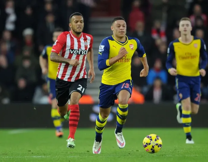 Framed Print : Intense Rivalry: Oxlade-Chamberlain vs. Bertrand Clash in Southampton vs. Arsenal Premier League Showdown (January 2015)