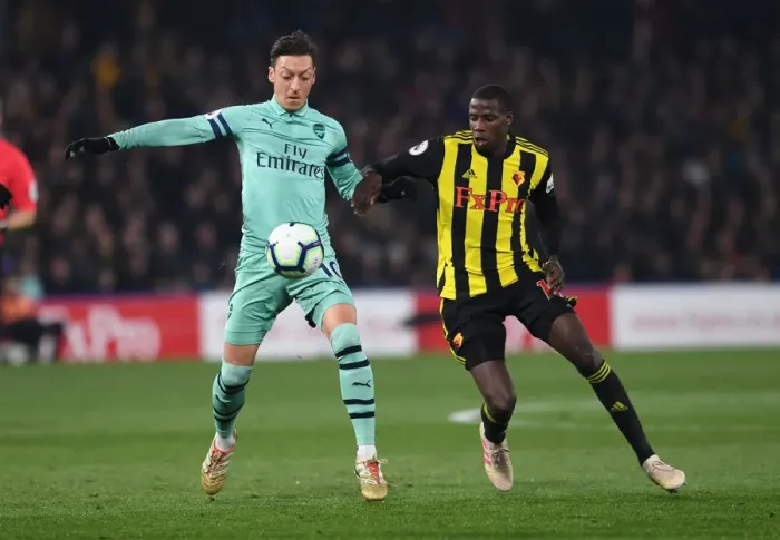 Framed Print : Intense Rivalry: Ozil vs Doucoure Showdown - Watford vs Arsenal Premier League (2018-19)
