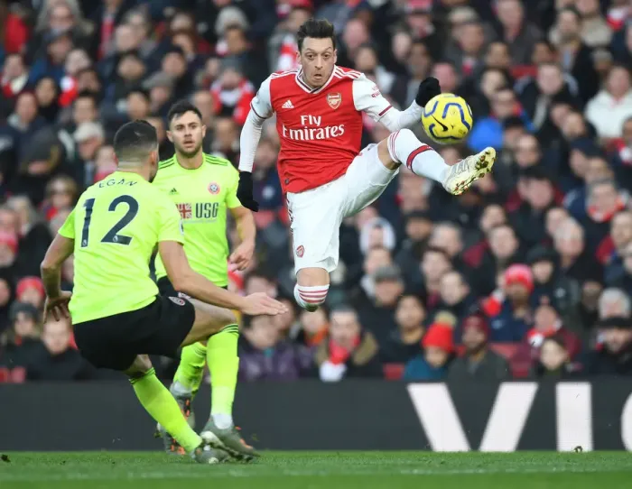 Framed Print : Intense Rivalry: Ozil vs. Egan - Arsenal vs. Sheffield United Clash in the Premier League Framed Print : Intense Rivalry: Ozil vs. Egan - Arsenal vs. Sheffield United Clash in the Premier League