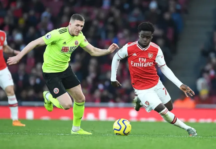 Framed Print : Intense Showdown: Bukayo Saka vs. John Lundstram in Arsenal's Battle Against Sheffield United Framed Print : Intense Showdown: Bukayo Saka vs. John Lundstram in Arsenal's Battle Against Sheffield United