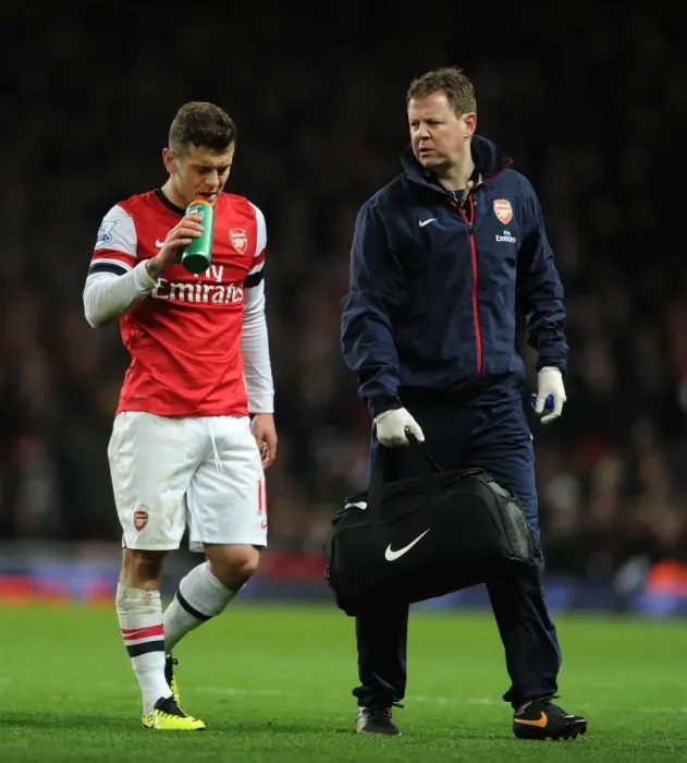 Framed Print : Jack Wilshere (Arsenal) and Arsenal Physio Colin Lewin. Arsenal 1: 1 Everton. Barclays