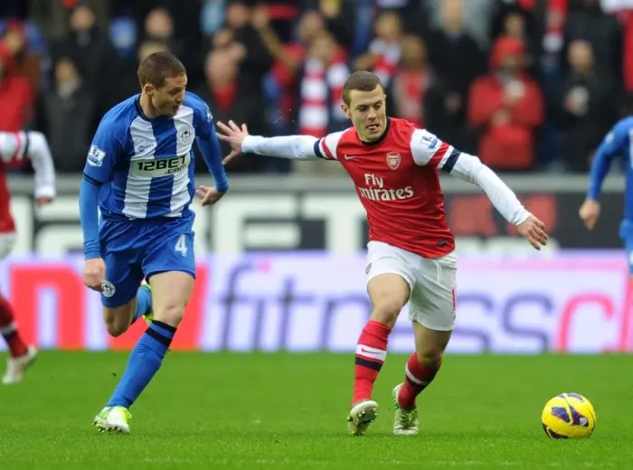 Framed Print : Jack Wilshere (Arsenal) James McCarthy (Wigan). Wigan Athletic 0: 1 Arsenal. Barclays Premier League