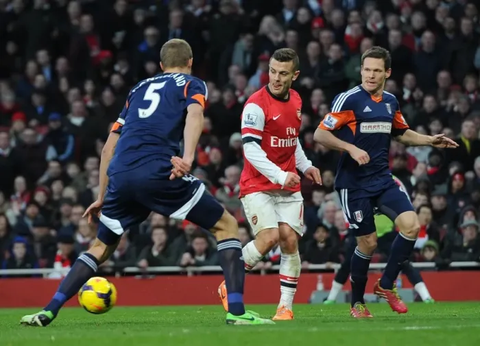 Framed Print : Jack Wilshere (Arsenal) passes for Santi Cazorlas 1st goal under pressure from Brede Hangeland
