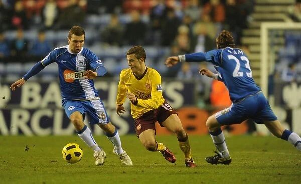 Jack Wilshere (Arsenal) Ronnie Stam and James McArthur (Wigan). Wigan Athletic 2