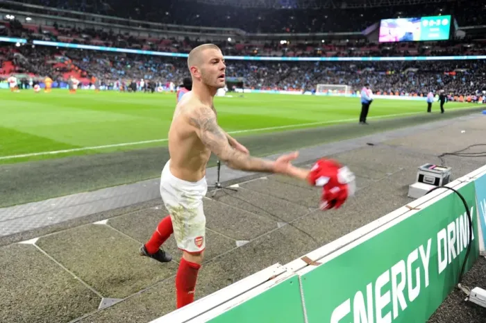 Framed Print : Jack Wilshere (Arsenal) throws his shirt to a fan after the match
