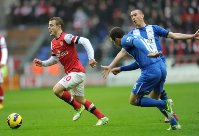 Framed Print : Jack Wilshere Darts Past David Jones and James McArthur (Wigan Athletic vs Arsenal, 2012-13)