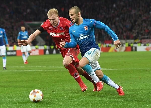 Jack Wilshere Dashes Past Fredrik Sorensen: Arsenal's Europa League Battle against 1. FC Koln