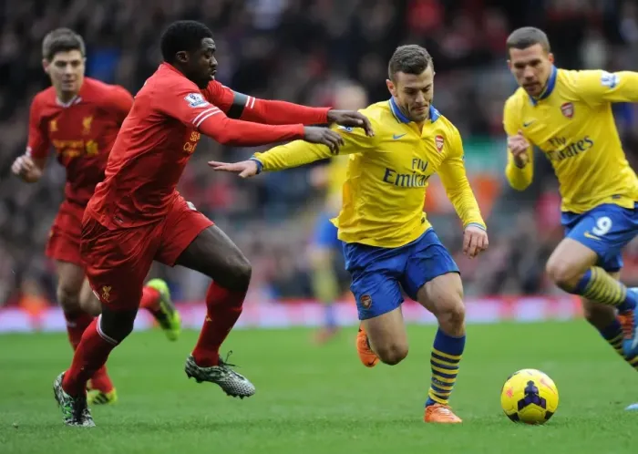 Framed Print : Jack Wilshere Outmaneuvers Kolo Toure: Intense Rivalry in the Premier League Clash between Arsenal and Liverpool