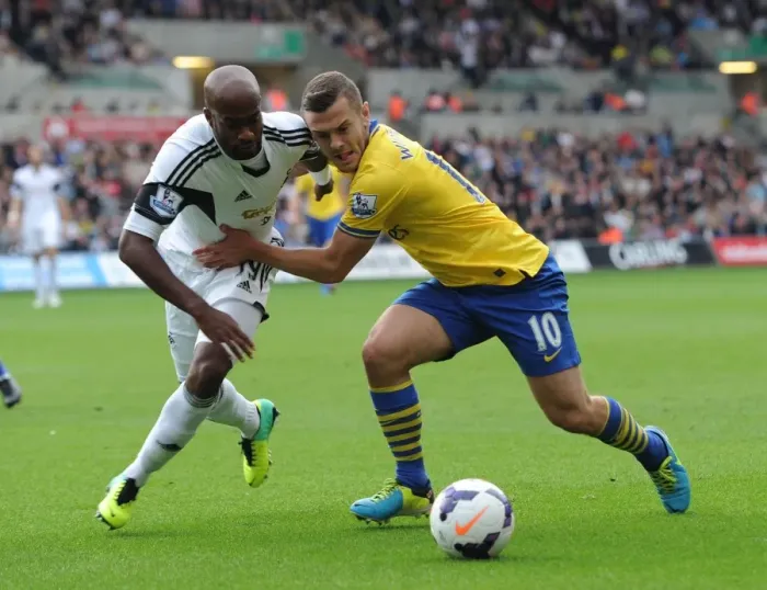 Framed Print : Jack Wilshere vs. Dwight Tiendalli: Intense Battle in Swansea City vs. Arsenal Premier League Clash Framed Print : Jack Wilshere vs. Dwight Tiendalli: Intense Battle in Swansea City vs. Arsenal Premier League Clash