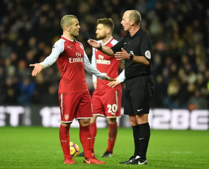 Framed Print : Jack Wilshere vs Mike Dean: Heated Confrontation during Arsenal's Match at West Bromwich Albion