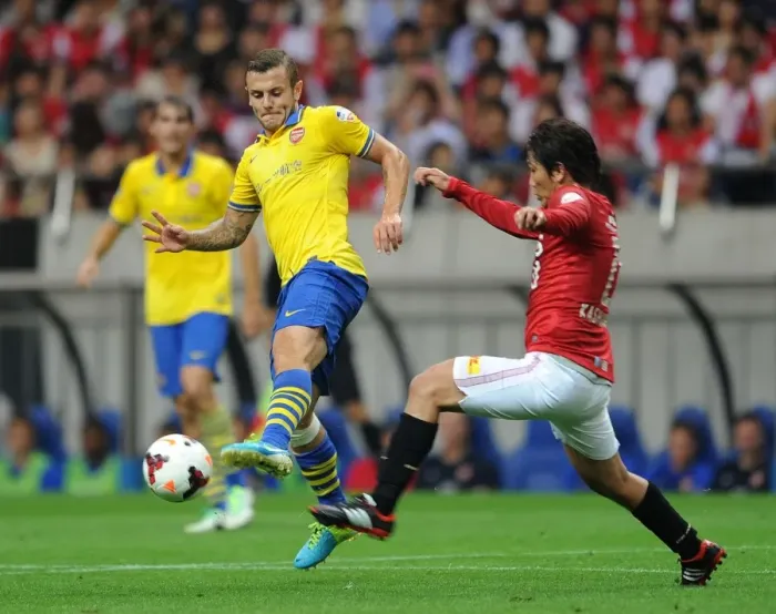 Framed Print : Jack Wilshere vs. Yosuke Kashiwagi: Clash of Midfielders in Urawa Red Diamonds vs. Arsenal (2013)