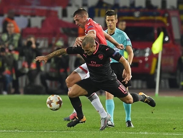 Jack Wilshere's Dominance: Overpowering Nenad Krsticic in the Europa League Clash between Arsenal and Crvena Zvezda