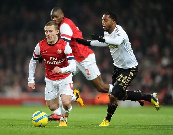 Jack Wilshere's Electrifying Run: Arsenal's Midfield Maestro Outshines Swansea's Agustien in FA Cup Third Round Replay