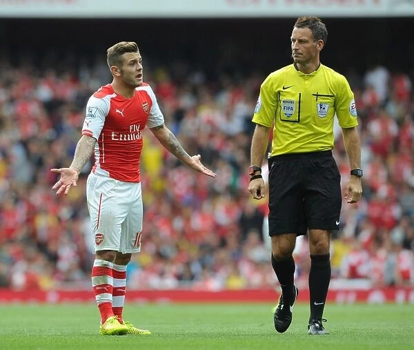 Jack Wilshere's Passionate Protest: Arsenal Star Faces Off with Referee Mark Clattenburg during Arsenal vs Manchester City (2014-15)