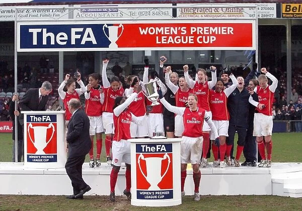 Jayne Ludlow and Anita Asante lift the League Cup Trophy for Arsenal