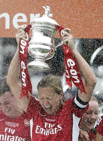 Jayne Ludlow (Arsenal) lifts the FA Cup Trophy