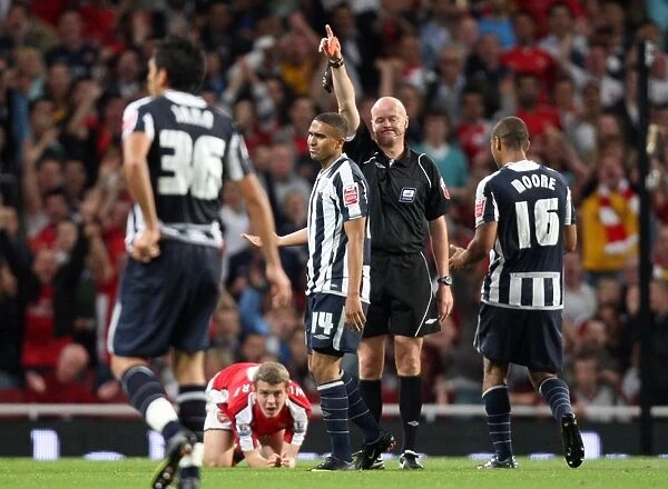 Jerome Thomas (WBA) is shown the red card by referee Lee Mason as Jack Wilshere 