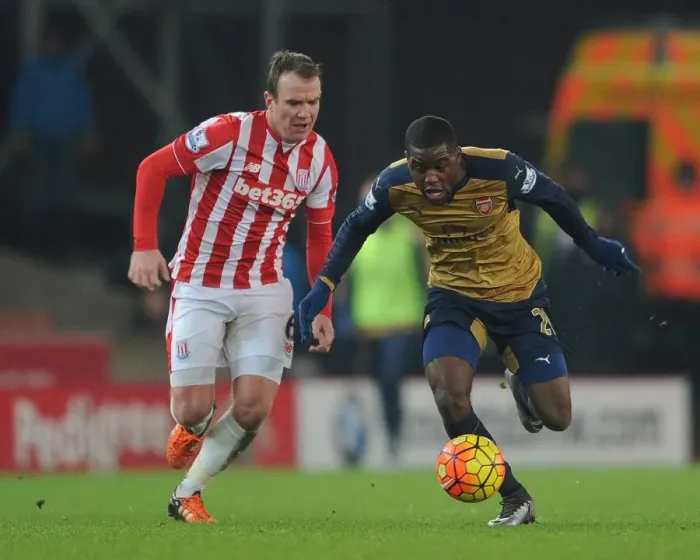 Framed Print : Joel Campbell's Slick Move: Outmaneuvering Glenn Whelan in the Stoke City vs. Arsenal Clash