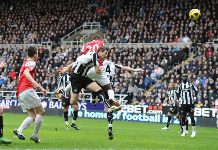 Framed Print : Johan Djourou heads past Newcastle goalkeeper Steve Harper to score the 2nd Arsenal goal