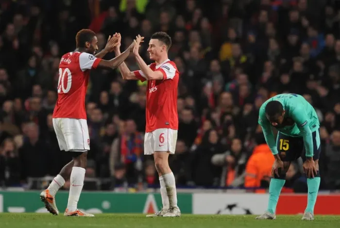 Framed Print : Johan Djourou and Laurent Koscielny (Arsenal) celebrates as a dejected Seydou Keita