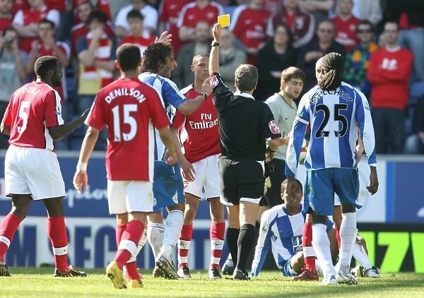 Kieran Gibbs (Arsenal) is shown the yellow card by the referee for a foul