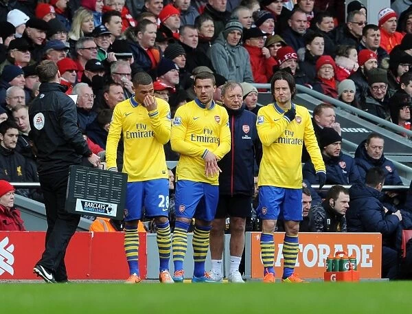 Kieran Gibbs, Lukas Podolski and Tomas Rosicky (Arsenal) prepare to come on as substitutes