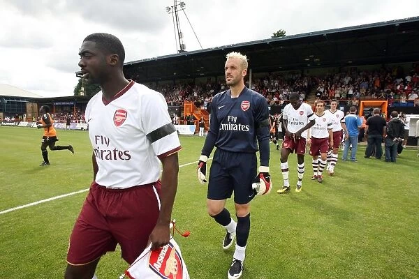 Kolo Toure and Manuel Almunia (Arsenal) lead the team out