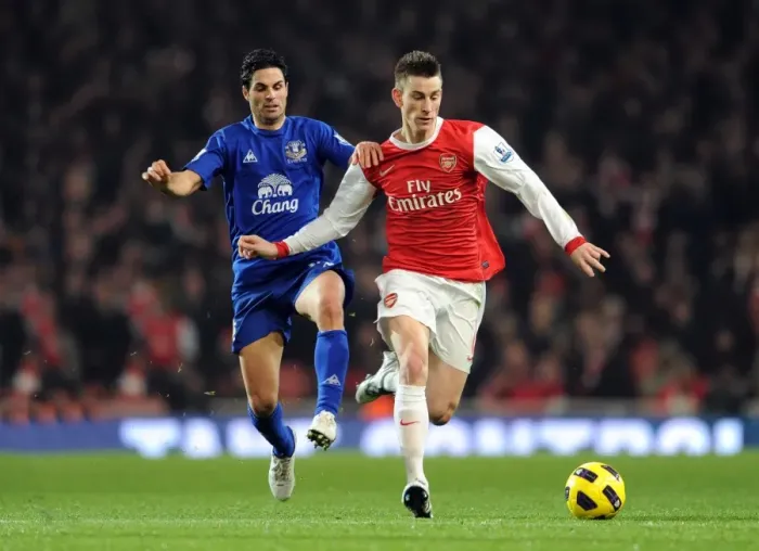 Framed Print : Koscielny vs. Arteta Clash: Arsenal's Win over Everton in the Barclays Premier League