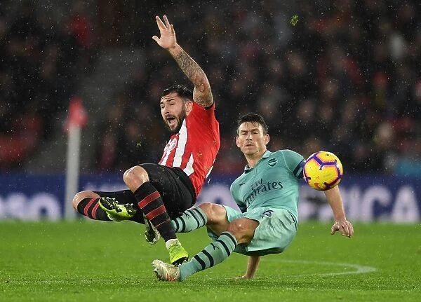 Koscielny vs. Austin: A Premier League Battle - Arsenal's Laurent Koscielny Clashes with Southampton's Charlie Austin (December 2018)