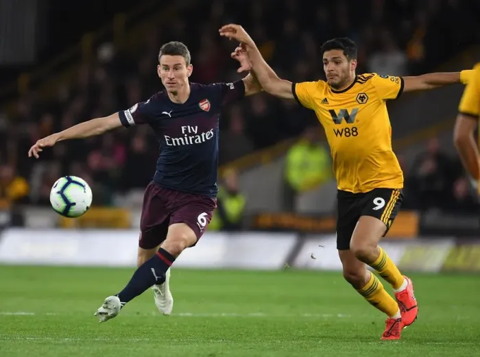 Framed Print : Koscielny vs. Jimenez: Intense Battle in Wolverhampton Wanderers vs. Arsenal FC Premier League Clash Framed Print : Koscielny vs. Jimenez: Intense Battle in Wolverhampton Wanderers vs. Arsenal FC Premier League Clash