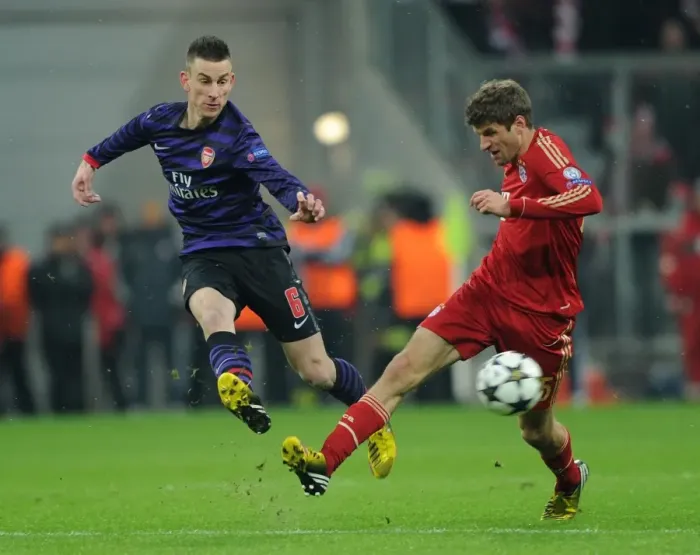 Framed Print : Koscielny vs. Muller: Intense Battle in Bayern Munich vs. Arsenal UEFA Champions League Clash Framed Print : Koscielny vs. Muller: Intense Battle in Bayern Munich vs. Arsenal UEFA Champions League Clash