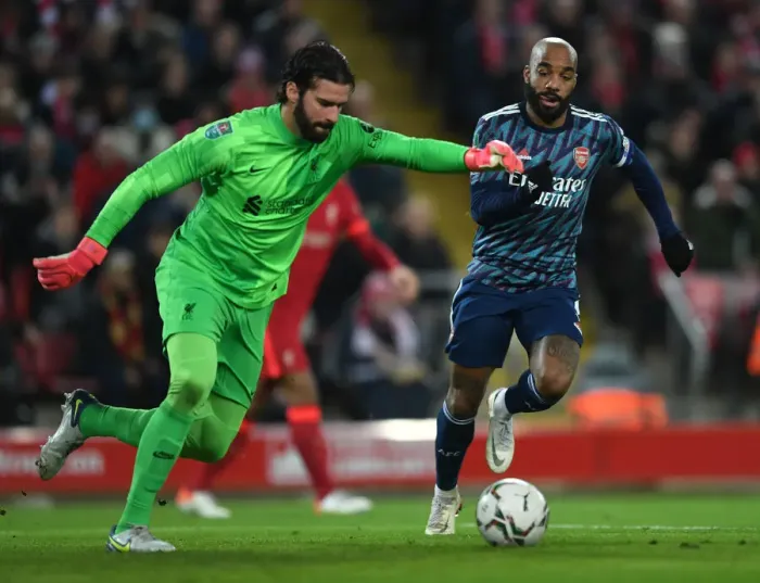 Framed Print : Lacazette vs Alisson: Intense Clash in Carabao Cup Semi-Final First Leg between Liverpool and Arsenal