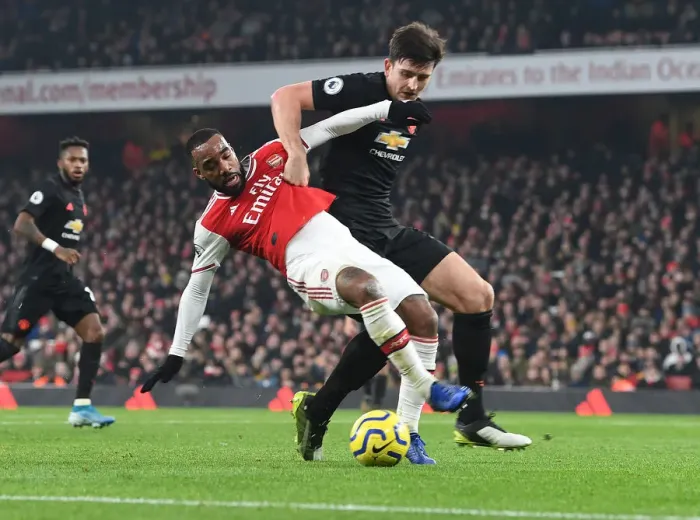 Framed Print : Lacazette vs Maguire: A Premier League Showdown at Emirates Stadium
