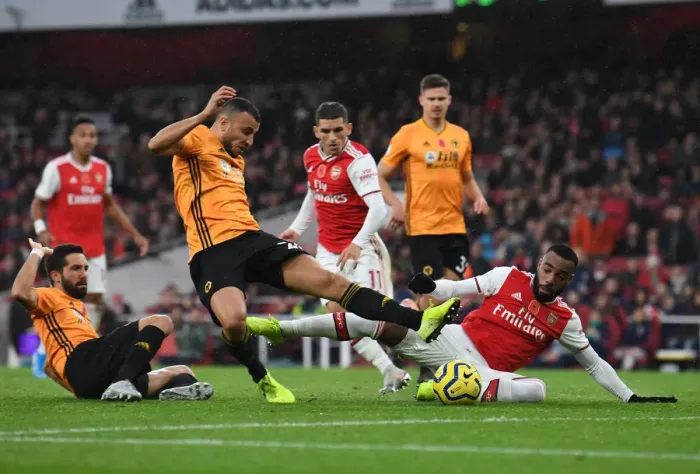 Framed Print : Lacazette vs. Saiss: A Premier League Showdown at Emirates Stadium