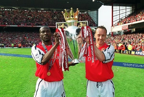 Lauren and Lee Dixon (Arsenal) lift the F.A.Barclaycard Premiership Trophy
