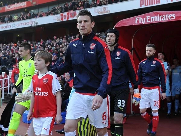 Laurent Koscielny (Arsenal) with the mascot before the match. Arsenal 2: 1 Burnley