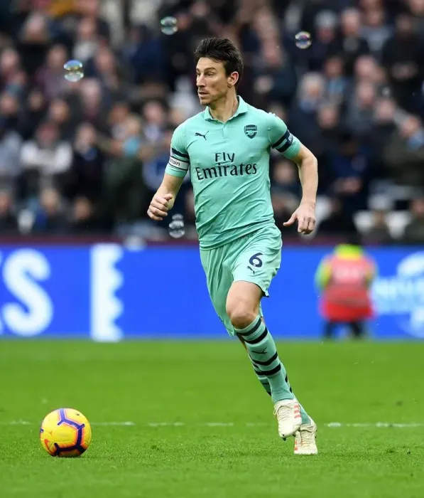 Framed Print : Laurent Koscielny: Unyielding Focus in the Heart of the Premier League Battle (West Ham United vs Arsenal FC, 2019)