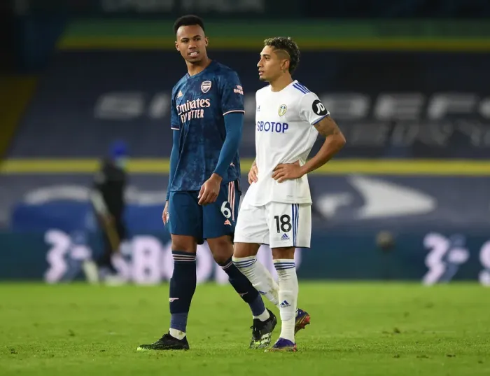 Framed Print : Leeds United vs. Arsenal: Gabriel Magalhaes and Raphinha Share a Moment After Intense Premier League Clash